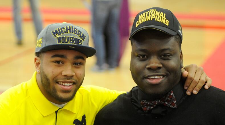 Wayne High School teammates Tyree Kinnel (left, University of Michigan) and Robert Landers (Ohio State) during National Signing Day ceremony at the school on Wednesday, Feb. 4, 2015. MARC PENDLETON / STAFF