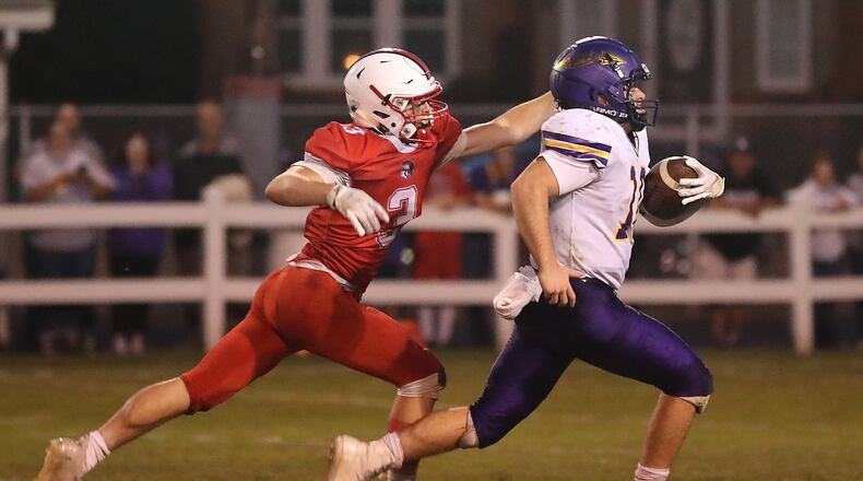 Southeastern's Thomas Sulfridge catches Mechanicsburg's Aaron Conley before he can cross the goal line during Friday night's game. BILL LACKEY/STAFF