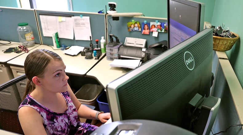 Ashlie Ray inputs information into the computers in the Clark County Clerk of Courts office Wednesday. The county is getting back on its feet after a virus shut down their computers earlier this week. BILL LACKEY/STAFF