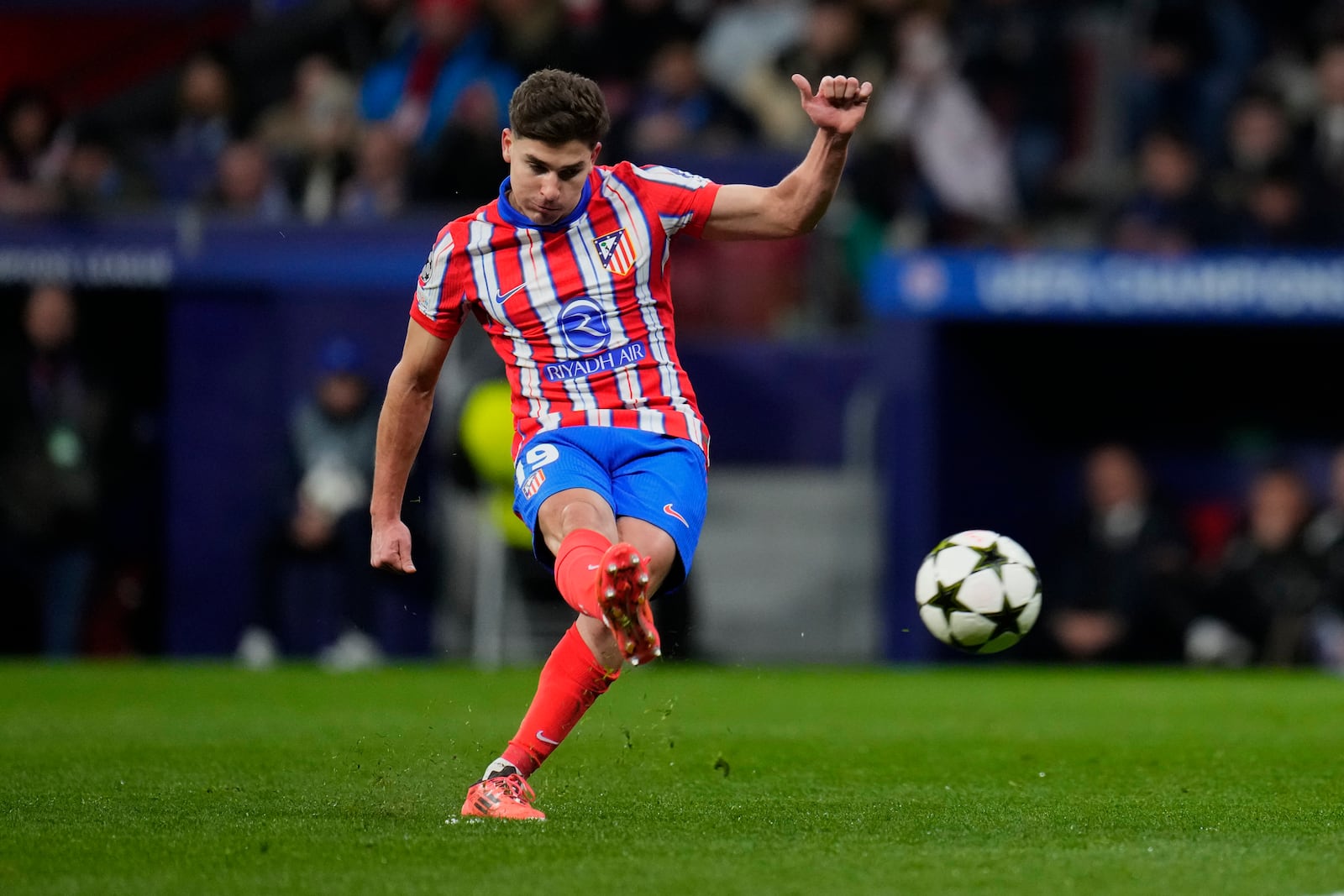 FILE - Atletico Madrid's Julian Alvarez shoots to score the opening goal during the Champions League opening phase soccer match between Atletico Madrid and Slovan Bratislava at Riyadh Air Metropolitano stadium in Madrid, Spain, Wednesday, Dec. 11, 2024. (AP Photo/Manu Fernandez, File)
