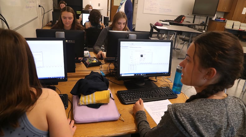 Shawnee seniors, including Audrey DeSantis, right, work on a project in a CCP class at the School. BILL LACKEY/STAFF