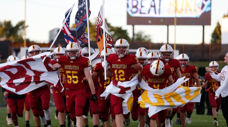 The Northeastern High School football team runs through a banner before its game against Mechanicsburg earlier this season at Conover Field in Springfield. CONTRIBUTED PHOTO BY MICHAEL COOPER