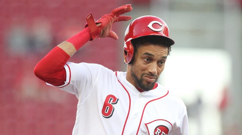 The Reds’ Billy Hamilton tries to hold onto his helmet as he runs to third base against the Cardinals on Thursday, April 12, 2018, at Great American Ball Park in Cincinnati. David Jablonski/Staff