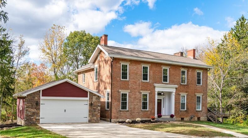 This brick antebellum style farmhouse was built in 1846 and has been updated with new bathrooms, HVAC and roof. It sits on 48 wooded acres in Xenia. CONTRIBUTED