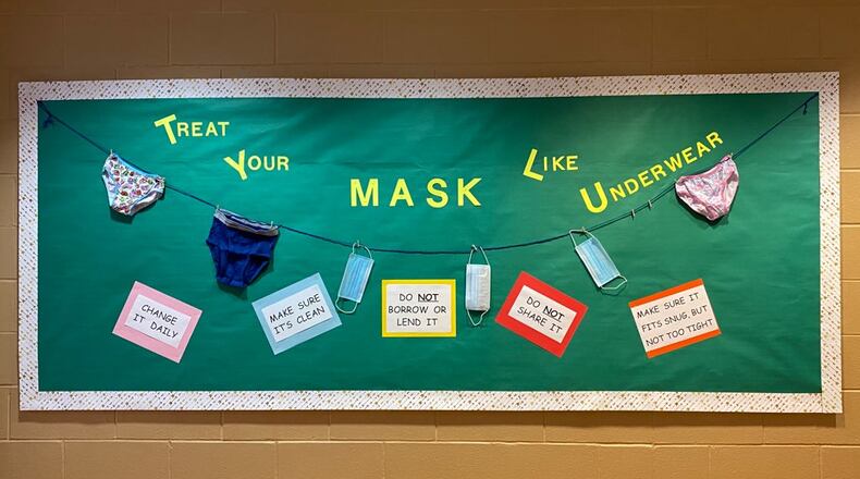 A bulletin board at Tecumseh Middle School reminding students and staff to wear a mask. CONTRIBUTED