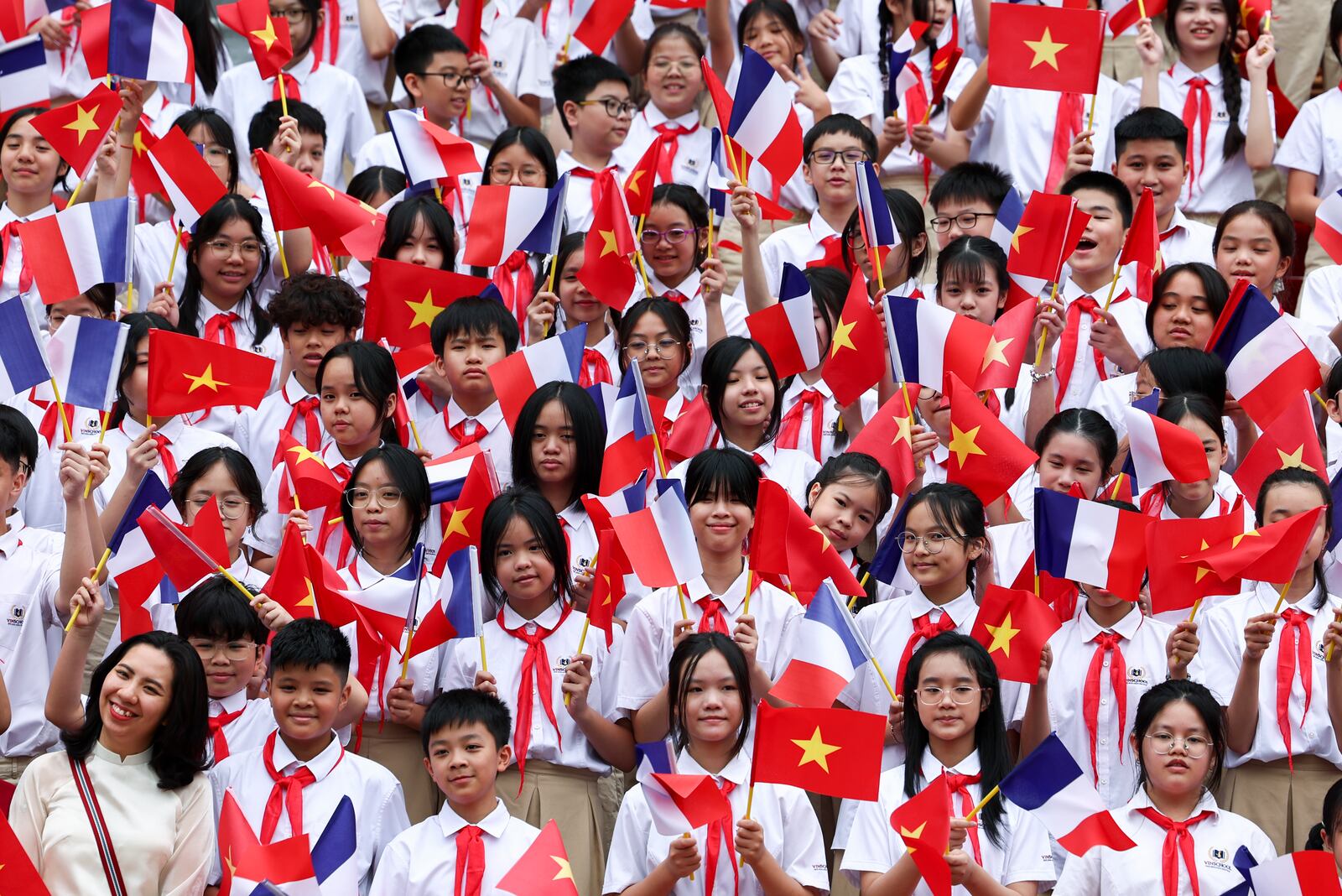 Children hold Vietnam's and France's flags at the welcome ceremony for French President Emmanuel Macron at the Presidential Palace in Hanoi, Vietnam Monday, May 26, 2025. (Chalinee Thirasupa/Pool Photo via AP)