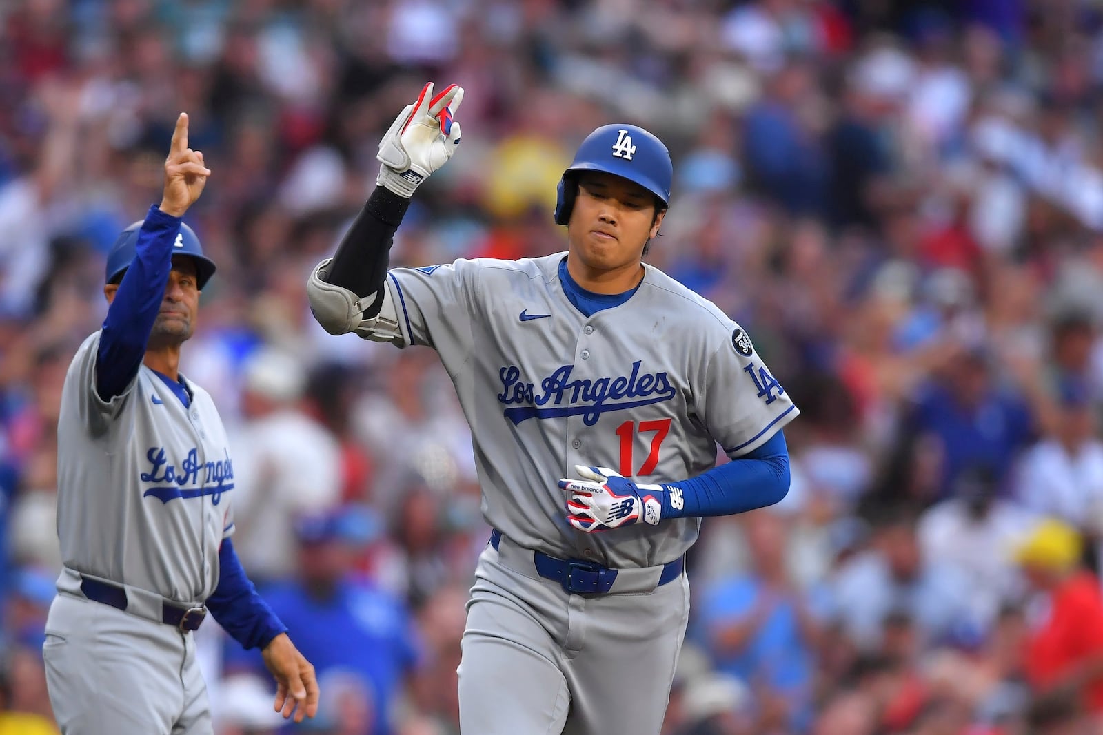 Los Angeles Dodgers' Shohei Ohtani (17) celebrates his home run in front of Dodgers third base coach Dino Ebel, left, in the first inning of a baseball game against the Boston Red Sox , Saturday, July 26, 2025, in Boston. (AP Photo/Steven Senne)