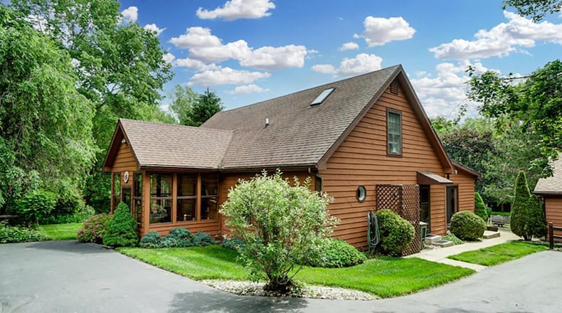 The 3-bedroom home offers about 2,080 sq. ft. of living space with a family room addition. The home is set on 15 acres, and a long drive leads to the garage and to the glass-enclosed front entry. CONTRIBUTED PHOTO