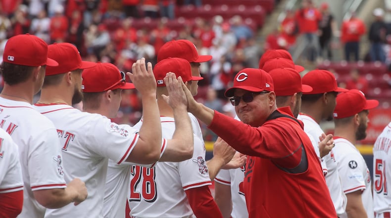 Reds manager Terry Francona slaps hands with players during pregame introductions on Opening Day at Great American Ball Park on Thursday, March 27, 2025, before a game against the Giants at Great American Ball Park in Cincinnati. David Jablonski/Staff