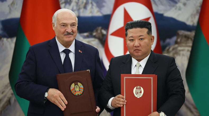 In this photo released by Belarus' Presidential Press Service, North Korea's leader Kim Jong Un, right, and Belarusian President Alexander Lukashenko hold signed documents during their meeting in Pyongyang, North Korea, Thursday, March 26, 2026. (Belarus' Presidential Press Service via AP)