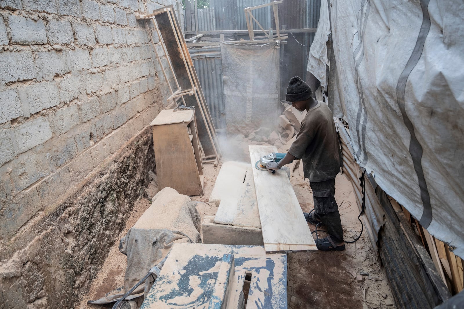 Isaac works in a carpentry shop that is powered in part by solar energy in Goma, Congo, May 23, 2025. (AP Photo/Moses Sawasawa)