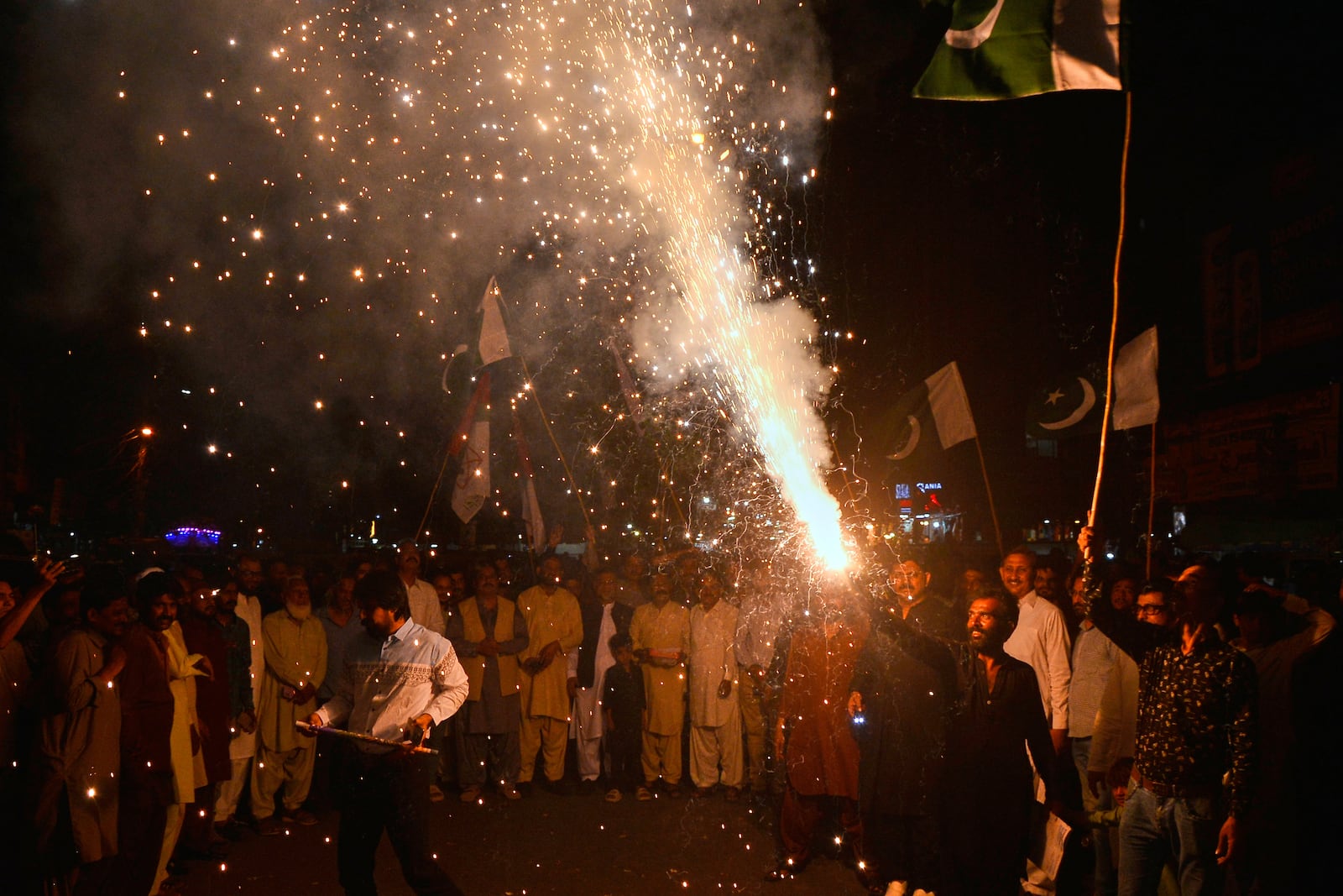People light fireworks to celebrate Pakistan and India reaching a ceasefire deal, during a demonstration in Hyderabad, Pakistan, Saturday, May 10, 2025. (AP Photo/Pervez Masih)