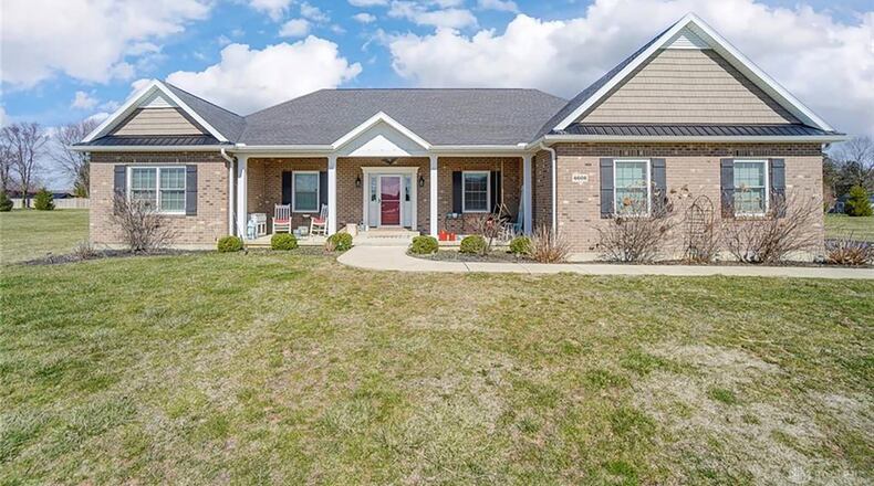 The front of the home features a covered concrete porch and side-entry, three-car garage. Contributed photos