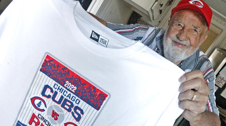Don "Spanky" Rinker holds up one of the Field of Dreams he picked up when he and his daughter, Kim, went to the recent game in Iowa between the Reds and Cubs. BILL LACKEY/STAFF