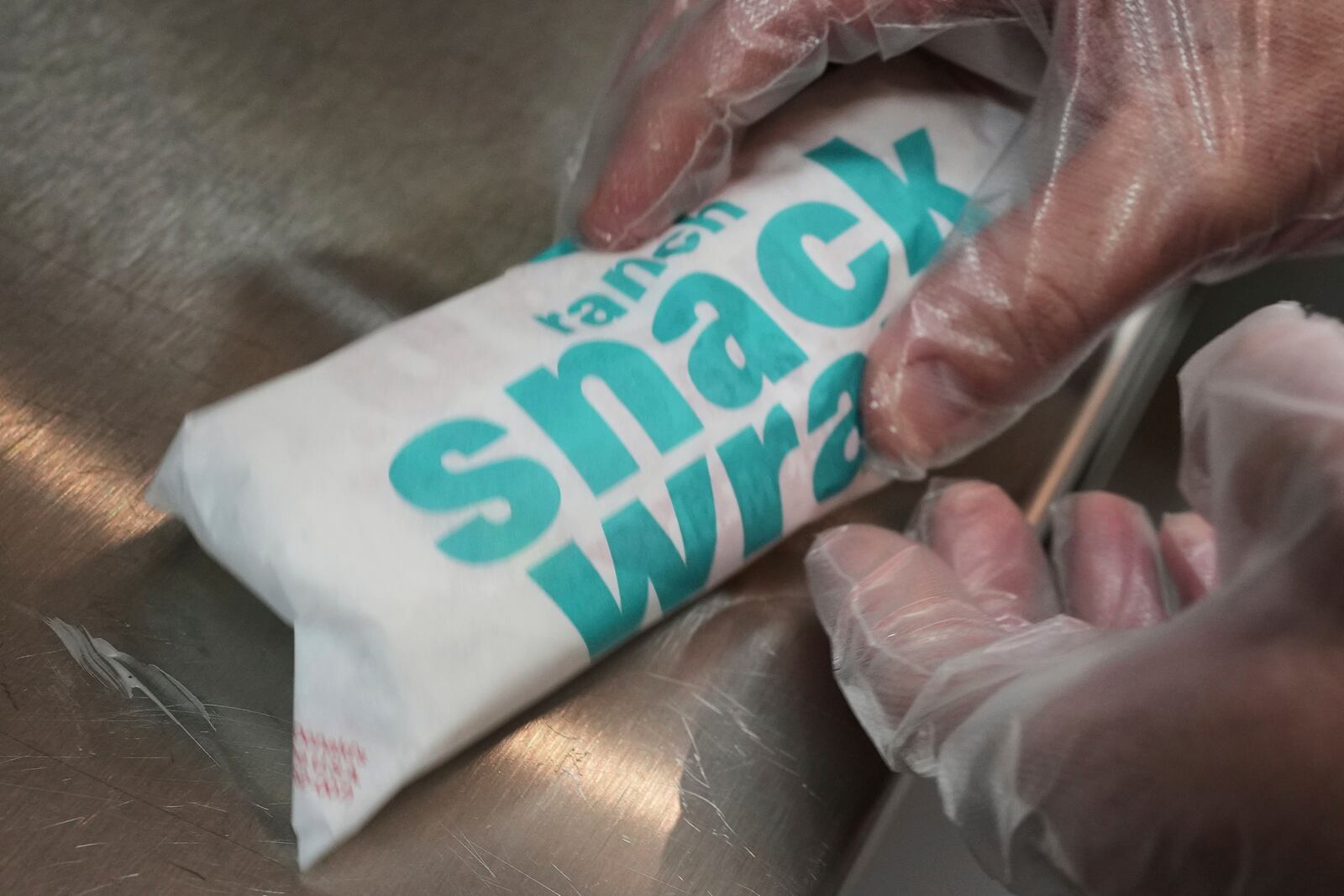 Wayne Kuhl, a McDonald's chef, wraps a snack wrap at McDonald's Headquarter in Chicago, Thursday, May 29, 2025. (AP Photo/Nam Y. Huh)