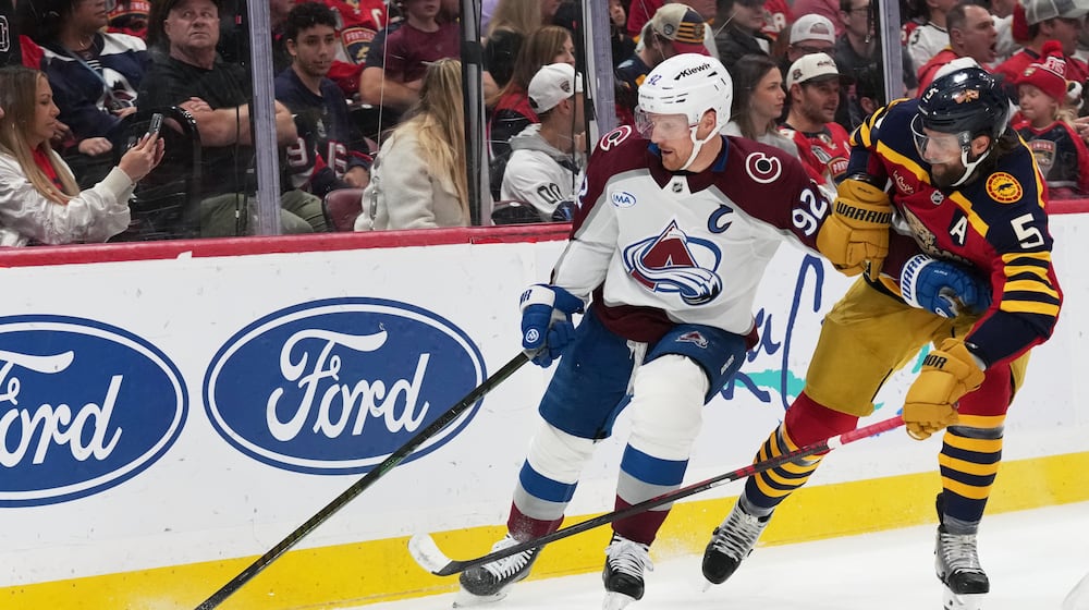 Colorado Avalanche left wing Gabriel Landeskog (92) skates with the puck as Florida Panthers defenseman Donovan Sebrango (6) defends during the first period of an NHL hockey game, Sunday, Jan. 4, 2026, in Sunrise, Fla. (AP Photo/Lynne Sladky)