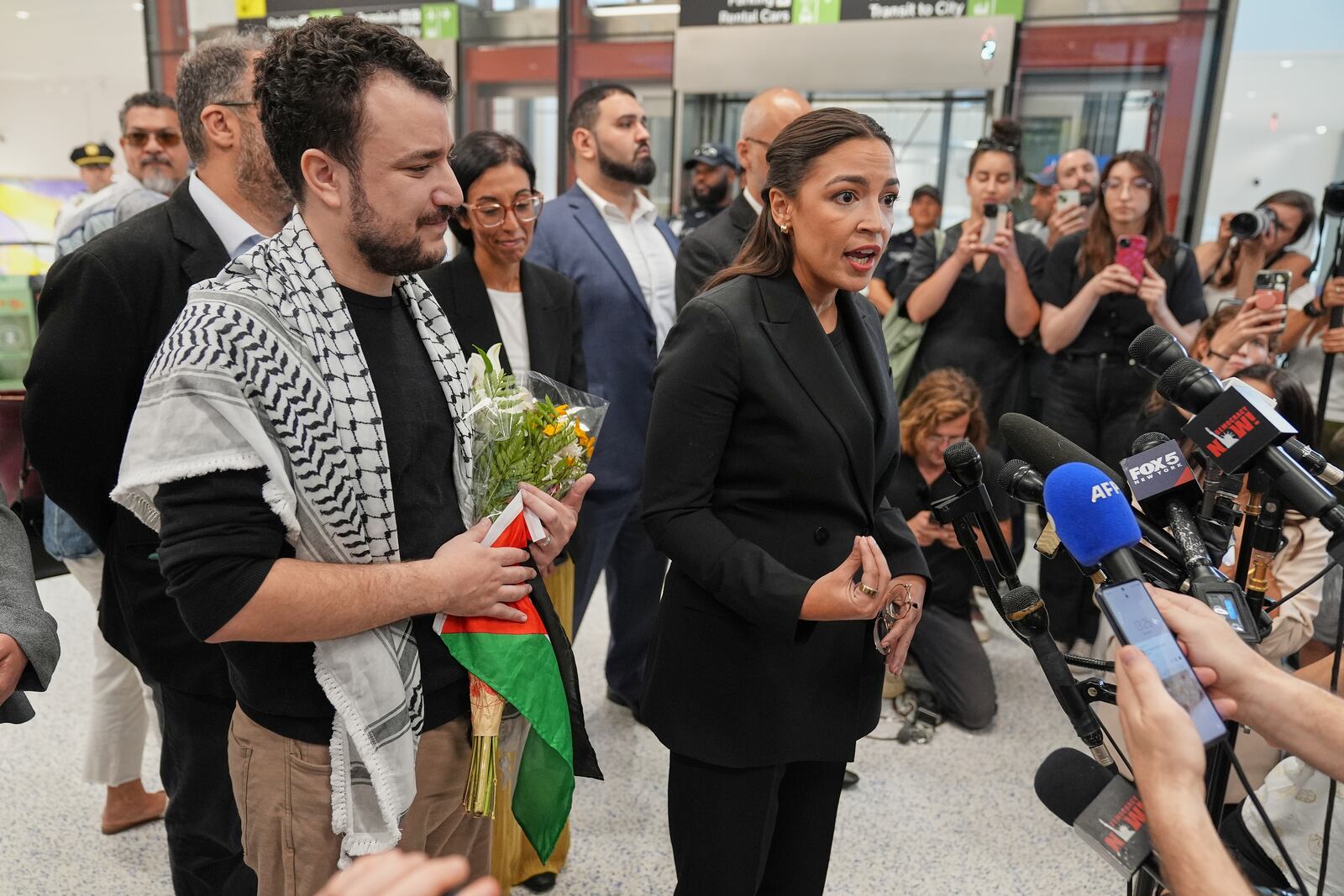 Rep. Alexandria Ocasio-Cortez, D-N.Y., speaks during a news conference after Mahmoud Khalil, left, arrived at Newark International Airport, Saturday, June 21, 2025, in Newark, N.J. (AP Photo/Seth Wenig)