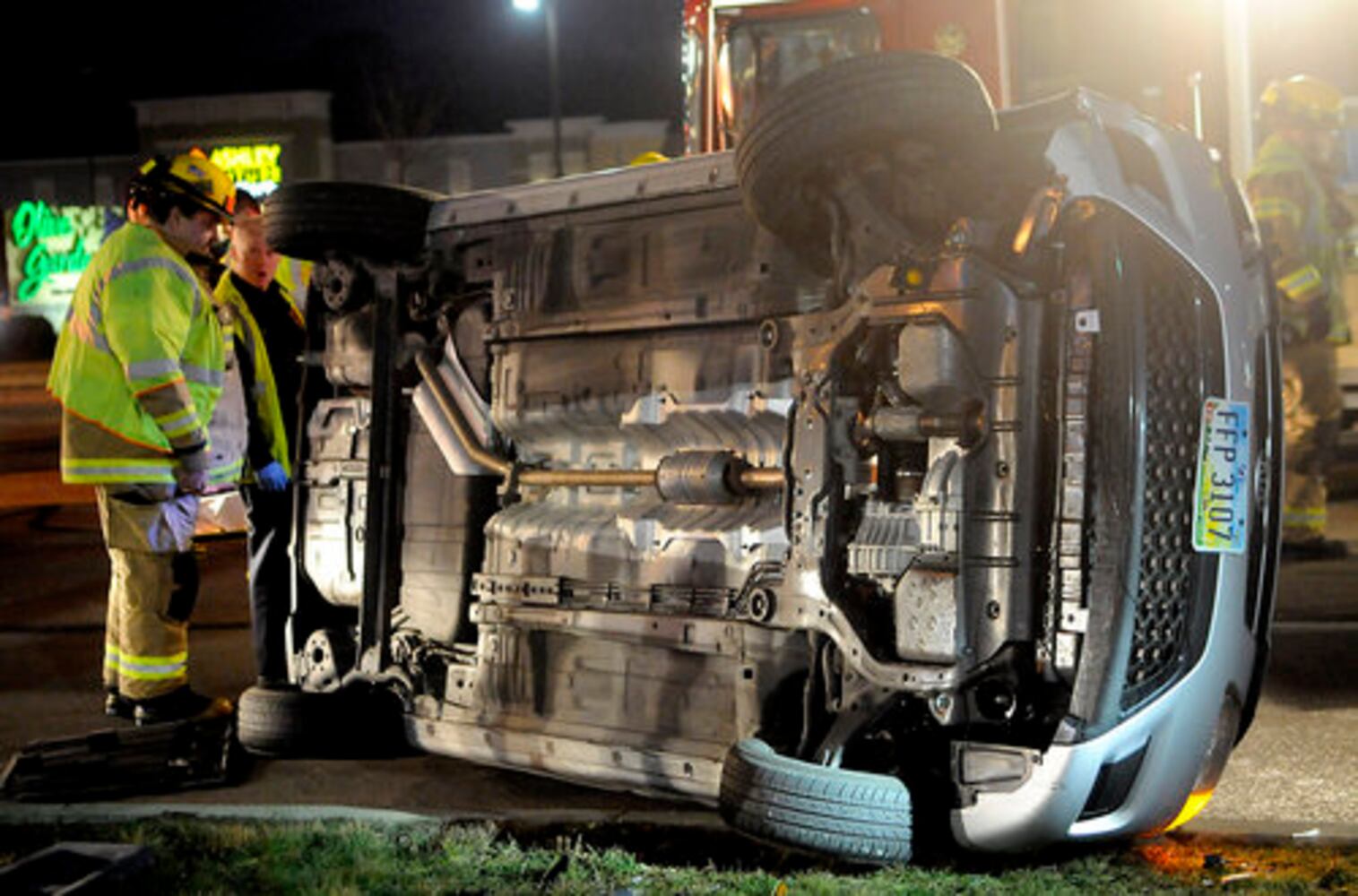 Car hits fire hydrant, turns on side