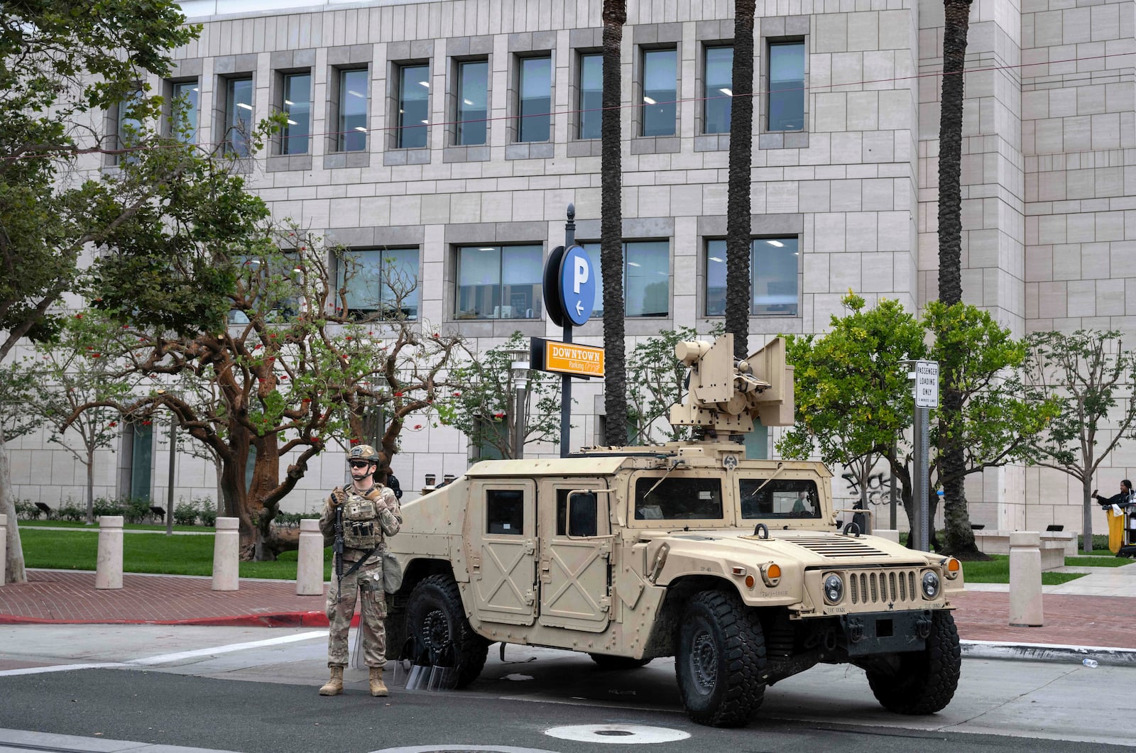 The California National Guard arrives to stand watch outside the Ronald Reagan Federal Building and Courthouse in Santa Ana, Calif., Tuesday, June 10, 2025, after Monday's protests against President Trump's ICE raids resulted in violence. (Mindy Schauer/The Orange County Register via AP)