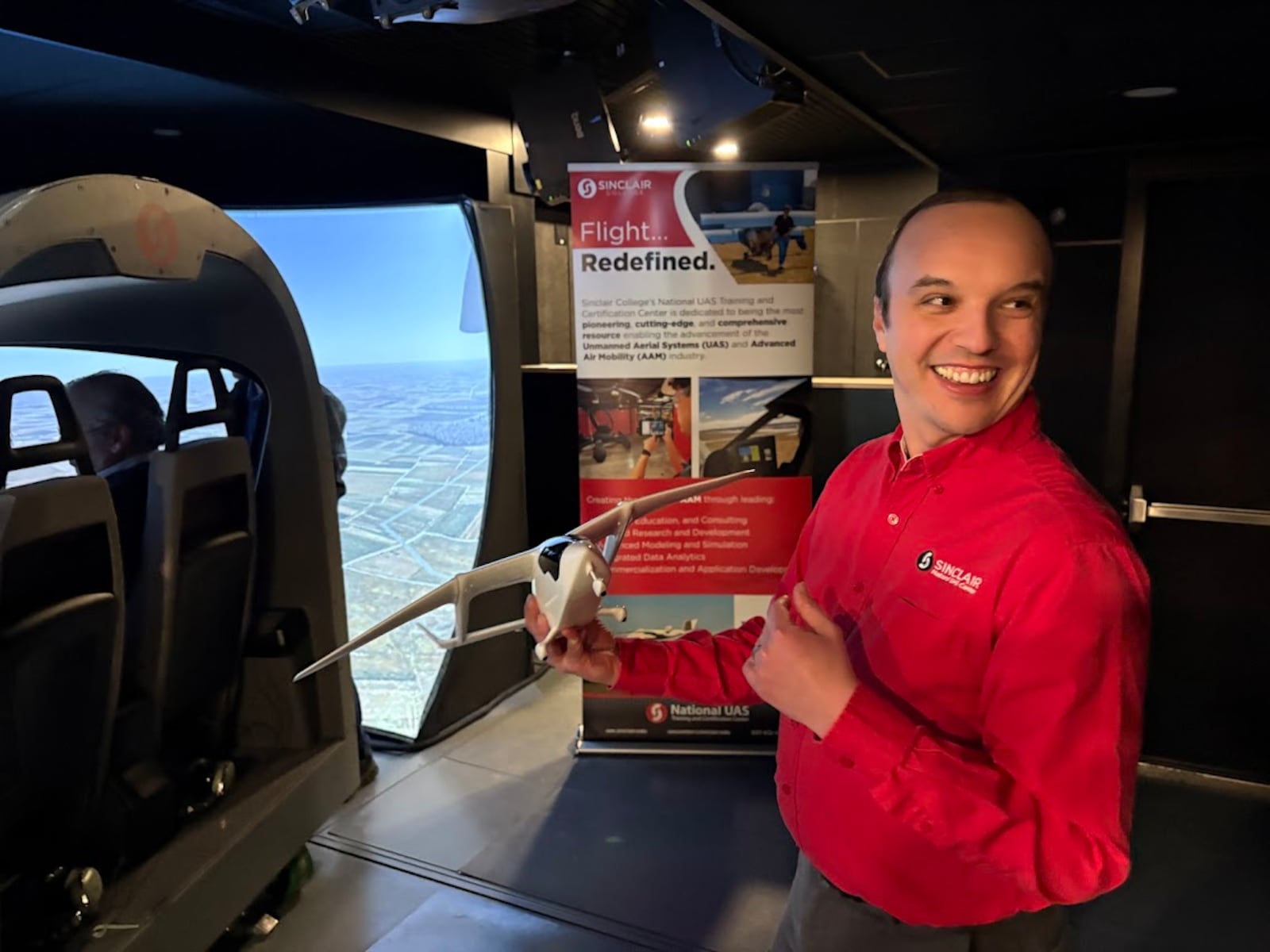Andrew Shepherd, Sinclair Community College chief research officer, talks Thursday, Feb. 5, 2026 at the Beta Technologies flight simulator trailer about the wonders of advanced air mobility. THOMAS GNAU/STAFF