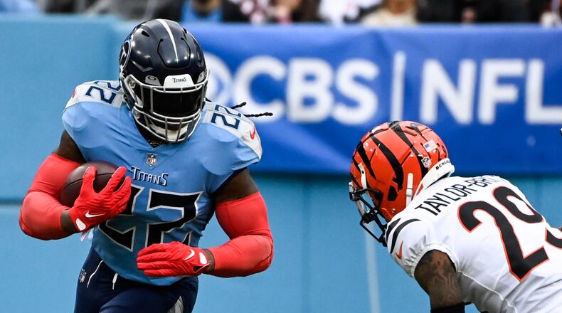 Tennessee Titans running back Derrick Henry (22) runs against Cincinnati Bengals cornerback Cam Taylor-Britt (29) during the first half of an NFL football game, Sunday, Nov. 27, 2022, in Nashville, Tenn. (AP Photo/Mark Zaleski)