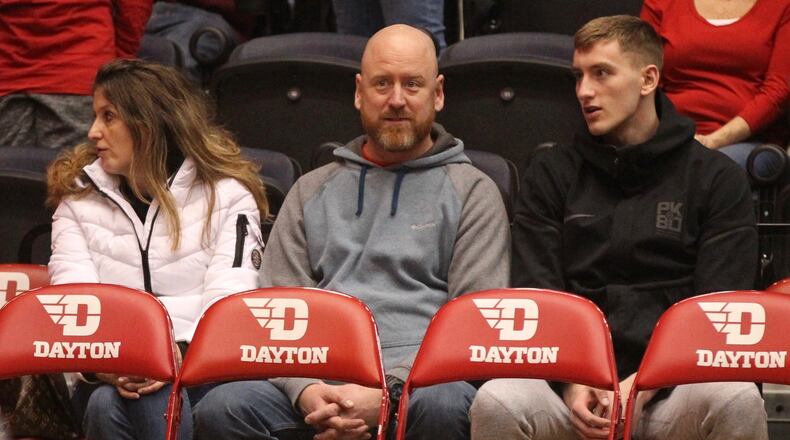 Chase Johnson, right, sits behind the Dayton bench during a game against Georgia Southern on Dec. 29, 2018, at UD Arena.