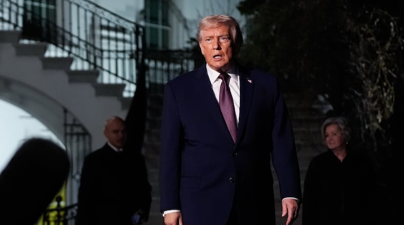 President Donald Trump walks to speak with reporters while departing the White House as chief of staff Susie Wiles, right, looks on, Friday, Dec. 19, 2025, in Washington. (AP Photo/Julia Demaree Nikhinson)