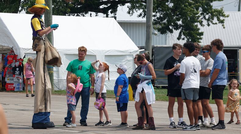 Sheriff Stretch makes balloon animals for a line of fairgoers Wednesday, July 24, 2024 at the Clark County Fair. BILL LACKEY/STAFF