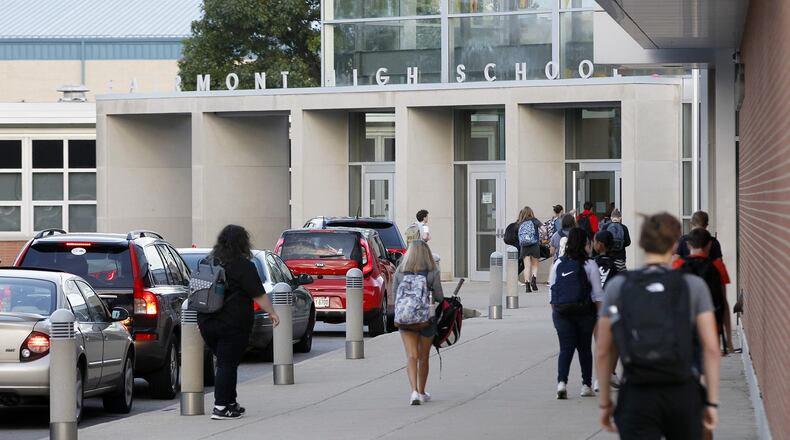 Students enter the main front door of Kettering Fairmont High School early on a fall morning. STAFF FILE PHOTO / TY GREENLEES