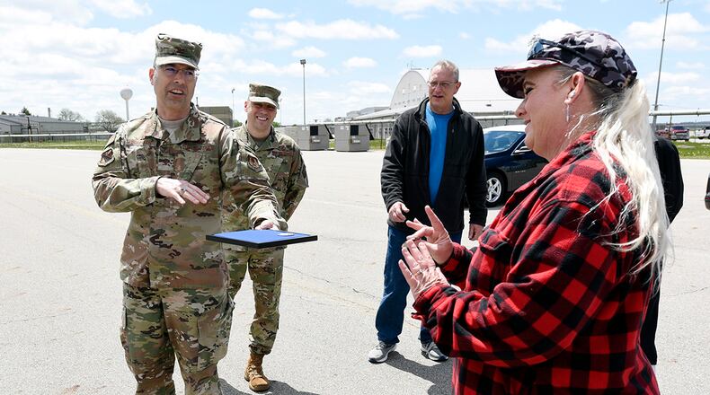 U.S. Air Force Col. Thomas Sherman, 88th Air Base Wing commander, awards 88th Civil Engineer Squadron Area A ground maintenance supervisor Aime Hass with an 88th ABW challenge coin at Wright-Patterson Air Force Base earlier this month. (U.S. Air Force photo by Ty Greenlees)