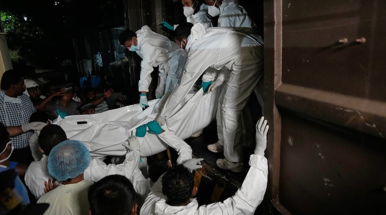 Healthcare workers unload the bodies of Iranian sailors from a vehicle who died when their IRIS Dena warship sank outside Sri Lanka's territorial waters, in Galle, Sri Lanka, Wednesday, March 4, 2026. (AP Photo/Eranga Jayawardena)