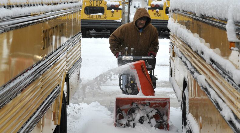 In this 2013 file photo: Tom Jenkins, a bus driver for Springfield City Schools, uses a snow blower to clear a path between the school district's buses Wednesday, March 6, 2013. Most schools in the area were closed Wednesday after several inches of snow fell across the area overnight. Bill Lackey/Staff