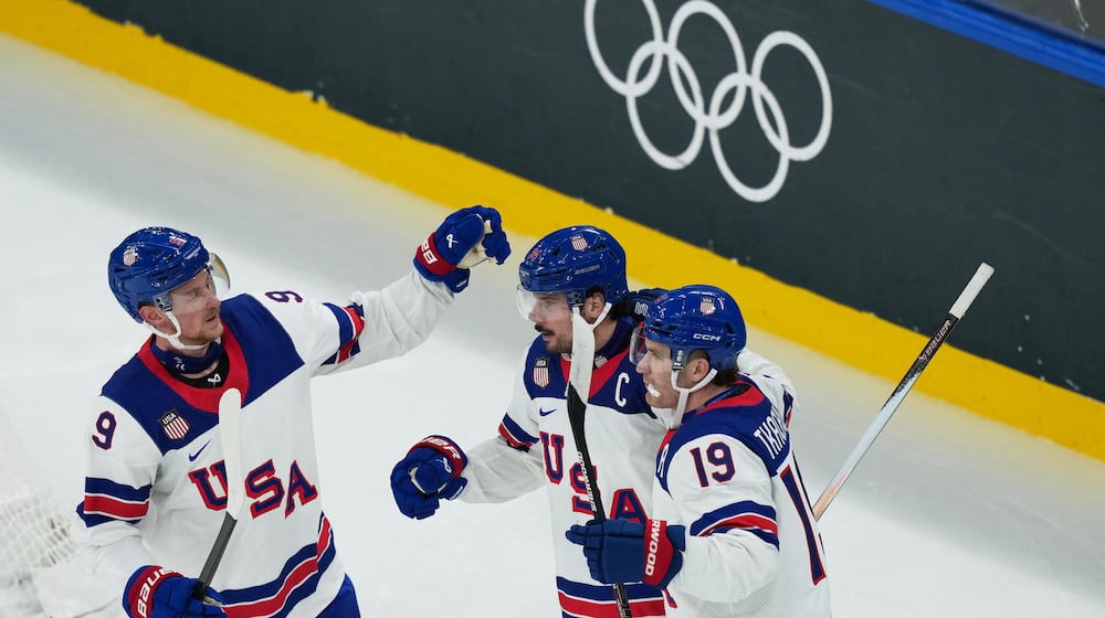 United States' Auston Matthews, center, celebrates with teammates after scoring his sides fifth goal during a preliminary round match of men's ice hockey between Latvia and the United States at the 2026 Winter Olympics, in Milan, Italy, Thursday, Feb. 12, 2026. (AP Photo/Carolyn Kaster)