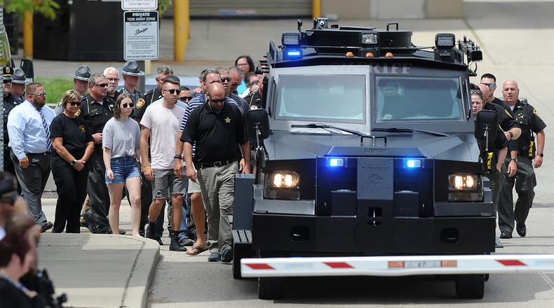 Members of the Clark County Sheriff's Office and members of other law enforcement agencies follow a SWAT vehicle carrying the body of fallen deputy Matthew Yates from the Montgomery County Corner's Office Monday July 25, 2022. The processional left Dayton to return Yates' body to Clark County. MARSHALL GORBY\STAFF
