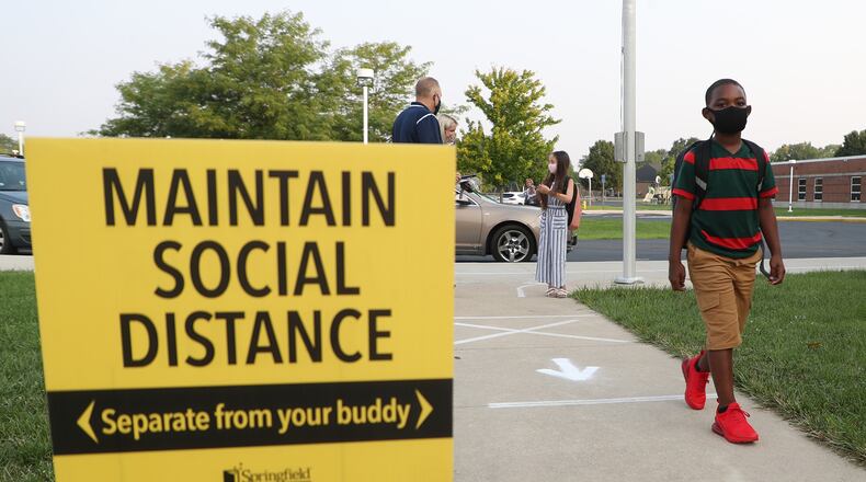Students walk into Simon Kenton Elementary for the first day of school Wednesday. BILL LACKEY/STAFF