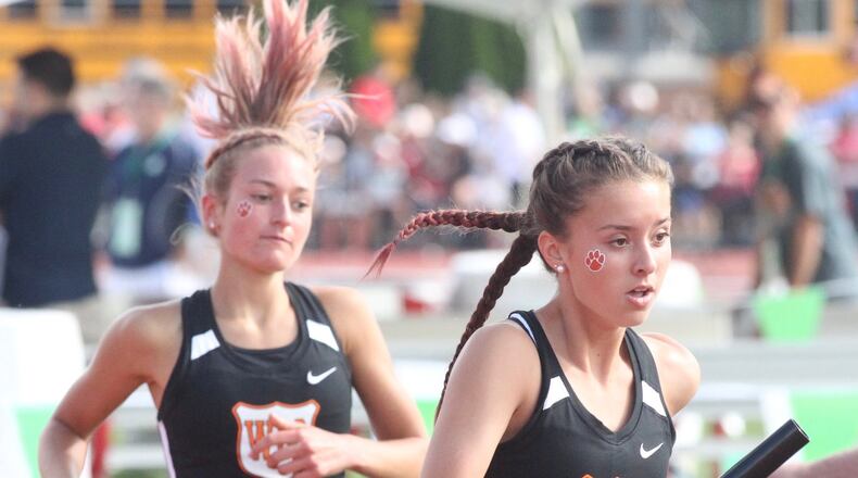 West Liberty-Salem’s Katelyn Stapleton, right, takes the baton from Madison Bahan for the final leg of the 4x800 relay at the Division III state track and field championships on Friday, May 31, 2019, at Jesse Owens Memorial Stadium in Columbus. David Jablonski/Staff