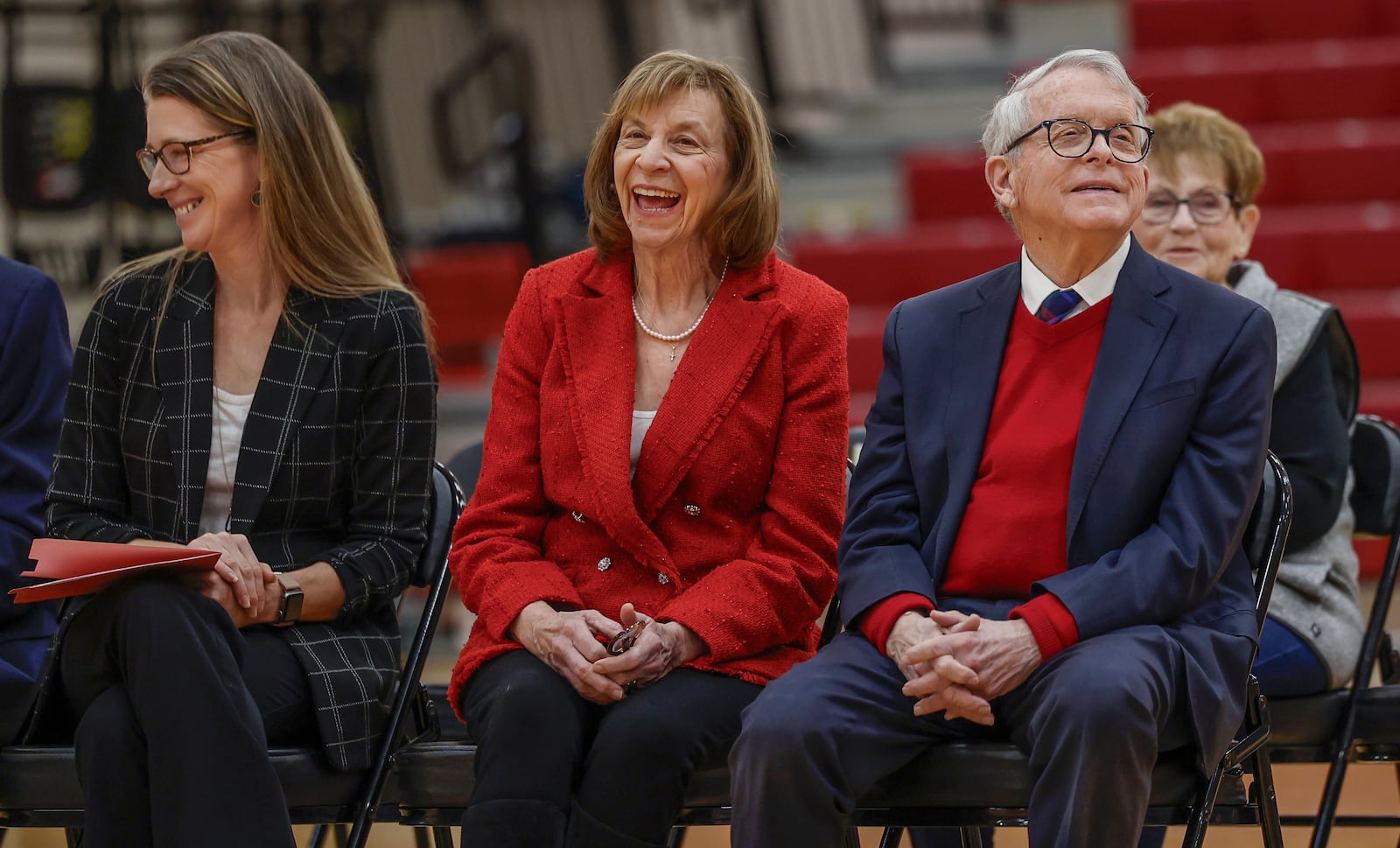 Tiffany Ways, left, chief school health officer of Health Partners of Western Ohio, First Lady Fran DeWine, center, and Ohio Gov. Mike DeWine share laughs as a speaker talks to students and teachers about the new children's eyesight program, OhioSEE, on Monday, Feb. 9, 2026, in South Vienna. JOSEPH COOKE/STAFF