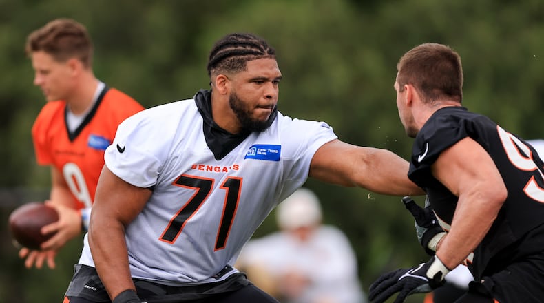 Cincinnati Bengals' La'el Collins, left, blocks Sam Hubbard during a drill at NFL football practice in Cincinnati, Tuesday, June 7, 2022. (AP Photo/Aaron Doster)
