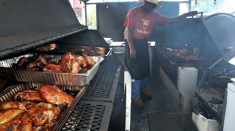 Richard Riddle, owner of Riddle's Ribs/Texas Cowboy Barbaque, mans the grills at his outdoor stand. Bill Lackey/Staff