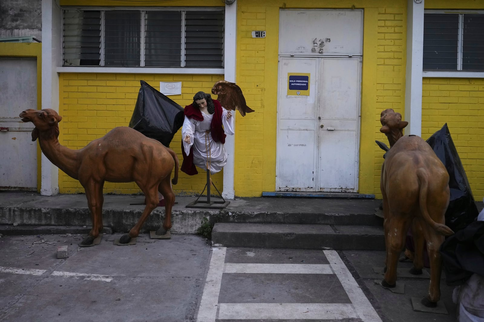 Religious statues sit outside, near a Catholic church that was damaged in Palin, Guatemala, Wednesday, July 9, 2025, after dozens of earthquakes and aftershocks were recorded in a matter of hours. (AP Photo/Moises Castillo)
