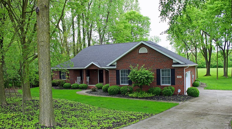 This brick ranch offers about 2,110 sq. ft. of living space with 3 bedrooms and formal living and dining rooms. The home has a screened porch and 2-car garage. CONTRIBUTED PHOTO BY VICKIE KAPNAS