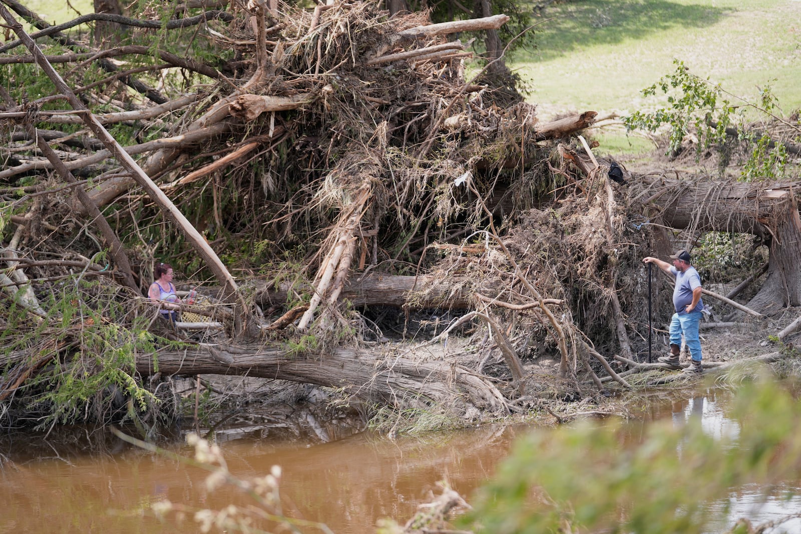 People search along the Guadalupe River after flooding in Kerrville, Texas on Wednesday , July 9, 2025. (AP Photo/Gerald Herbert)
