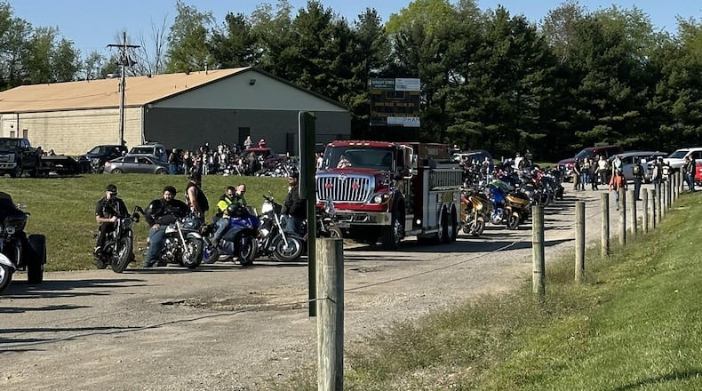 Motorcycles and other vehicles line up ahead of a drive-thru birthday celebration for Larkin Fulk, 5, who has leukemia. MARISSA BROOKS VIA FACEBOOK