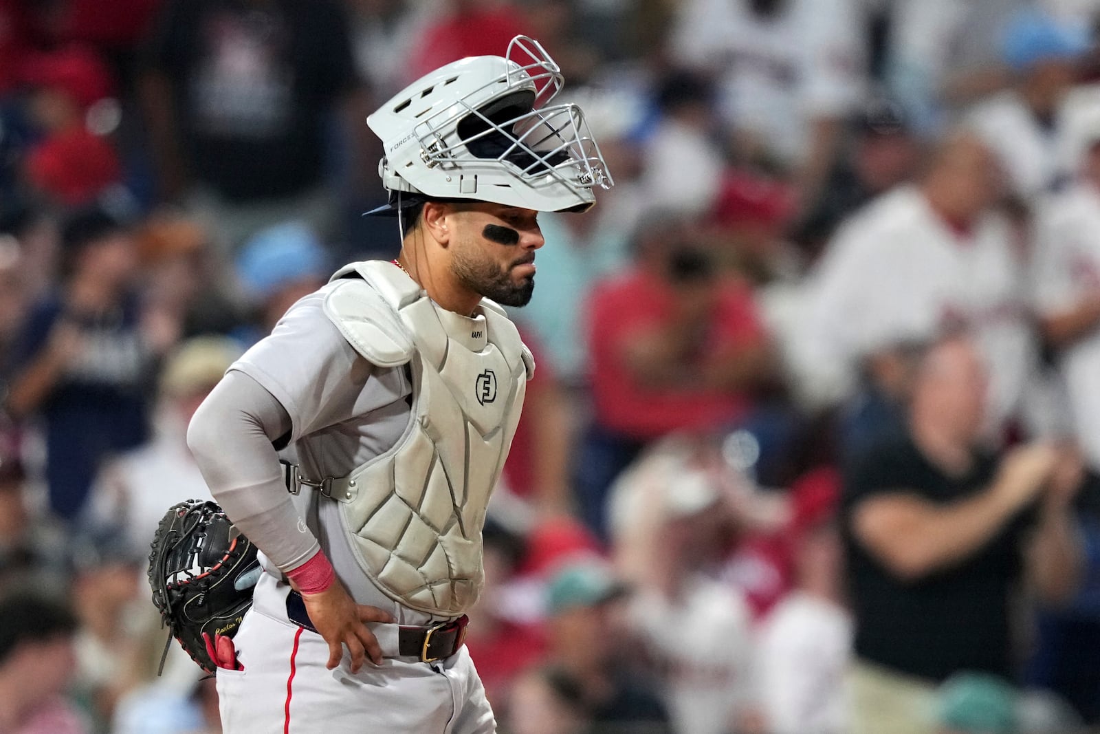 Boston Red Sox catcher Carlos Narváez waits for umpires to call catcher's interference on him during an at-bat by Philadelphia Phillies' Edmundo Sosa with the bases loaded during the 10th inning of a baseball game Monday, July 21, 2025, in Philadelphia. (AP Photo/Matt Slocum)