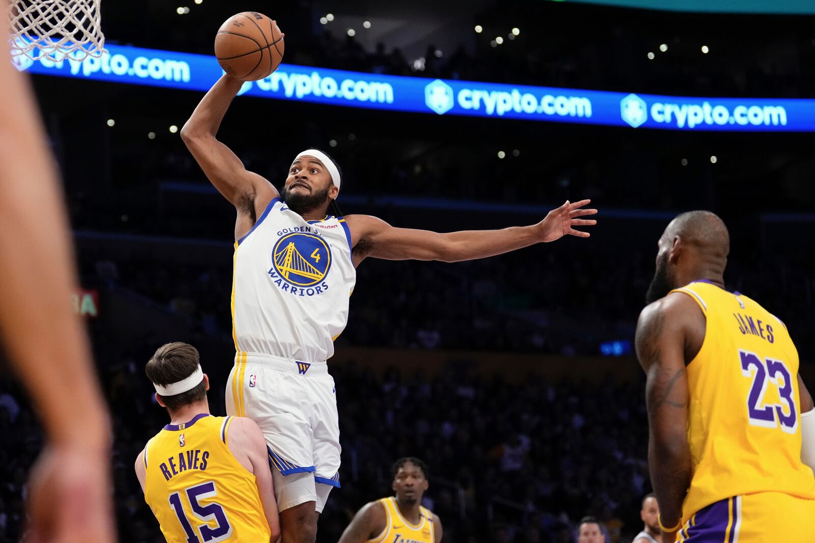 Golden State Warriors guard Moses Moody, center, shoots as Los Angeles Lakers guard Austin Reaves, left, and forward LeBron James defend during the first half of an NBA basketball game Thursday, April 3, 2025, in Los Angeles. (AP Photo/Mark J. Terrill)
