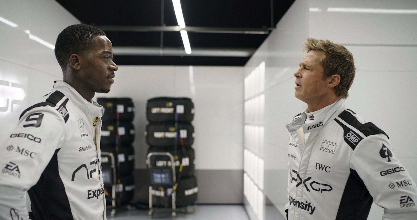 This image released by Apple TV+ shows Damson Idris as Joshua Pearce, left, and Brad Pitt as Sonny Hayes in a scene from "F1 The Movie." (Apple TV+ via AP)