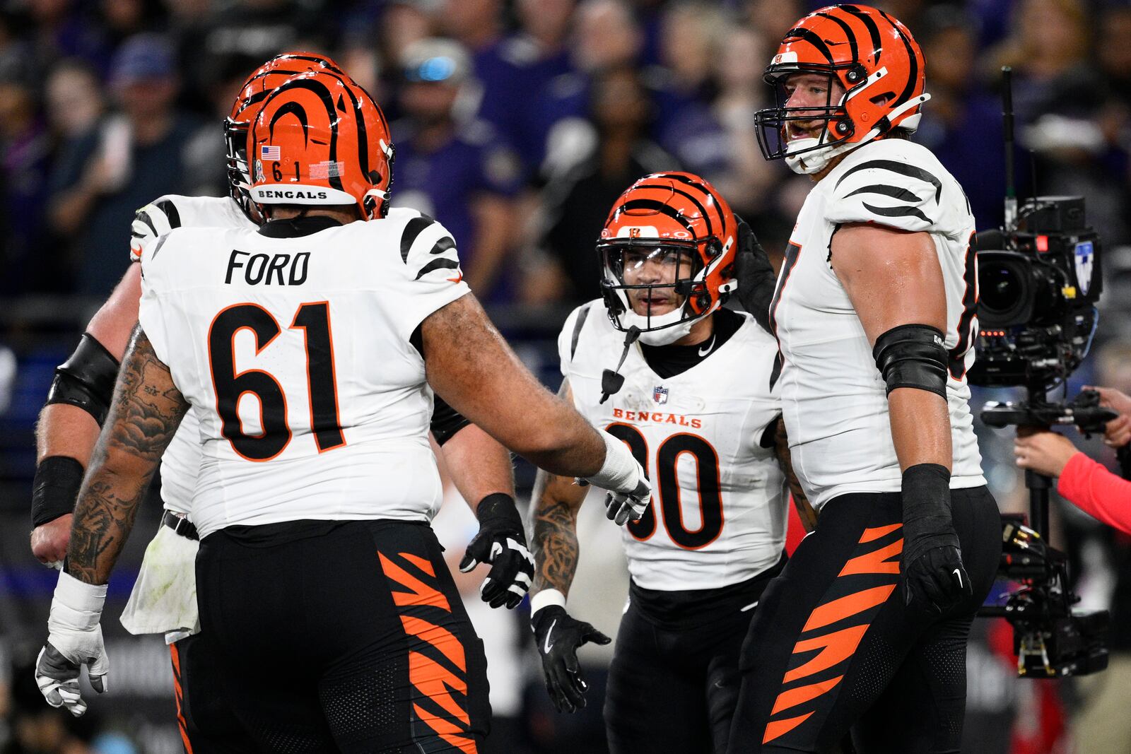 Cincinnati Bengals running back Chase Brown, second from right, celebrates scoring a touchdown with teammates, including Cincinnati Bengals guard Cody Ford (61), during the first half of an NFL football game against the Baltimore Ravens, Thursday, Nov. 7, 2024, in Baltimore. (AP Photo/Nick Wass)