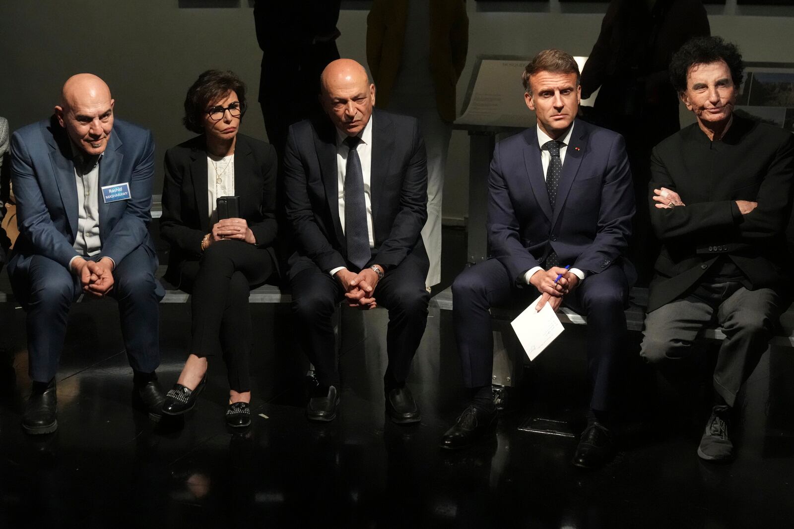 French President Emmanuel Macron, second right, IMA director Jack Lang, right, Palestinian film director Rashid Masharawi, left, French Culture minister Rachida Dati and Hani al-Hayek, center, the Palestinian Authority's minister for heritage and tourism listen as they visit the exhibition "Treasures rescued from Gaza" Monday, April 14, 2025 at the Arab World Institute (IMA) in Paris. (AP Photo/Michel Euler, Pool)