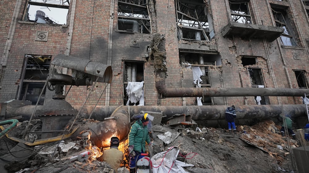 Workers clean up damage at Darnytsia Thermal Power Plant after a Russian attack in Kyiv, Ukraine, Wednesday, Feb. 4, 2026. (AP Photo/Sergei Grits)