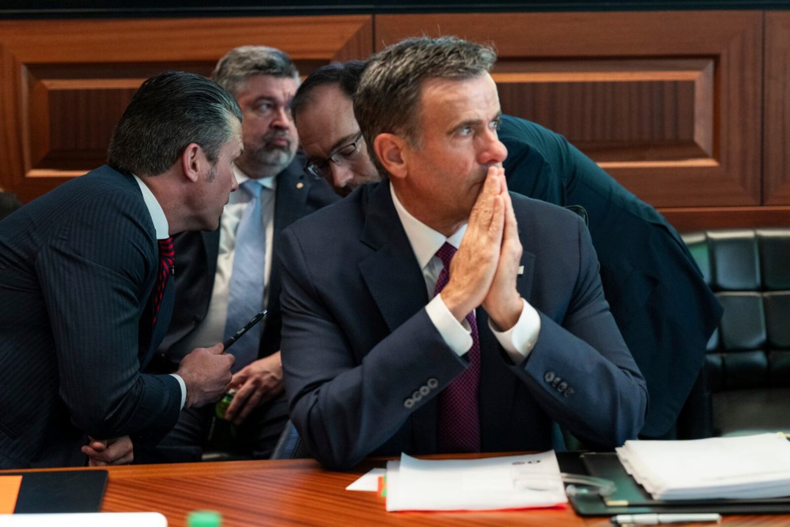 This image provided by the White House shows CIA Director John Ratcliffe, in foreground seated, as Defense Secretary Pete Hegseth, left, speaks with national security adviser Andy Baker with White House counsel David Warrington seated in background in the Situation Room, Saturday, June 21, 2025, at the White House in Washington. (The White House via AP)